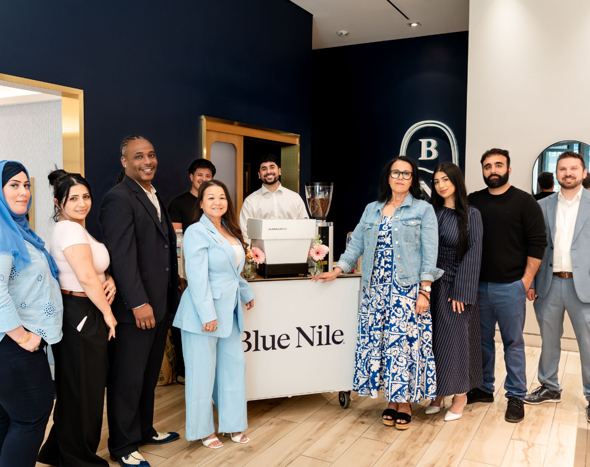 Blue Nile staff and guests gathered around the Fez Coffee branded espresso cart at the grand opening event