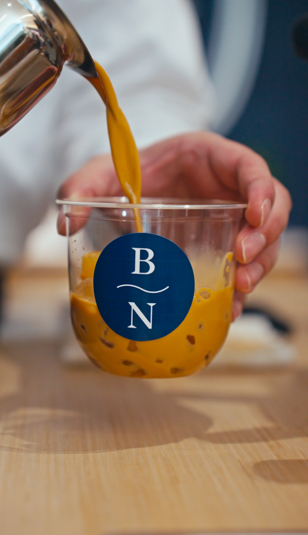 Espresso being poured into a custom Blue Nile branded cup at a Fez Coffee activation