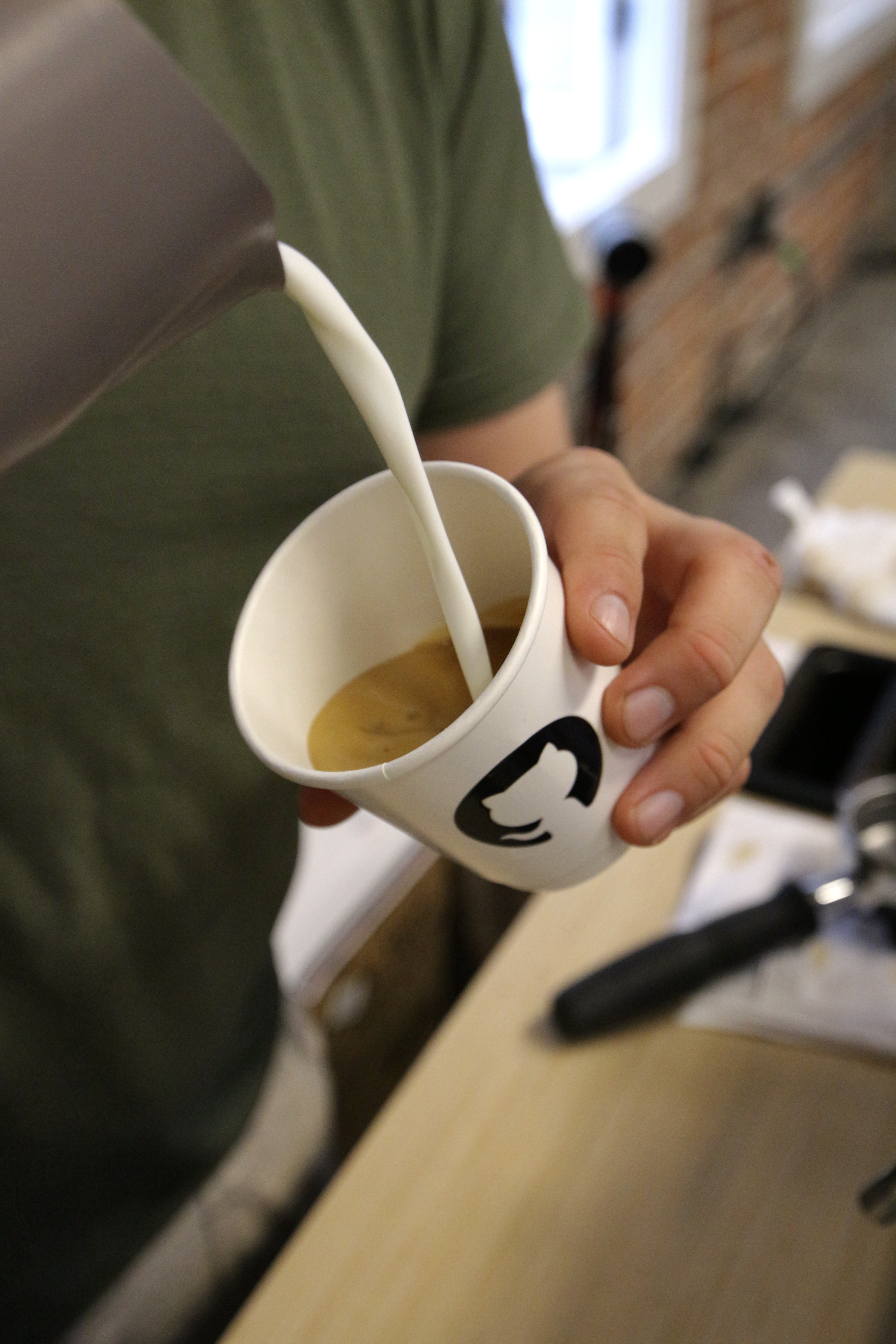 Espresso shot in a GitHub-branded cup at the Fez Coffee activation.