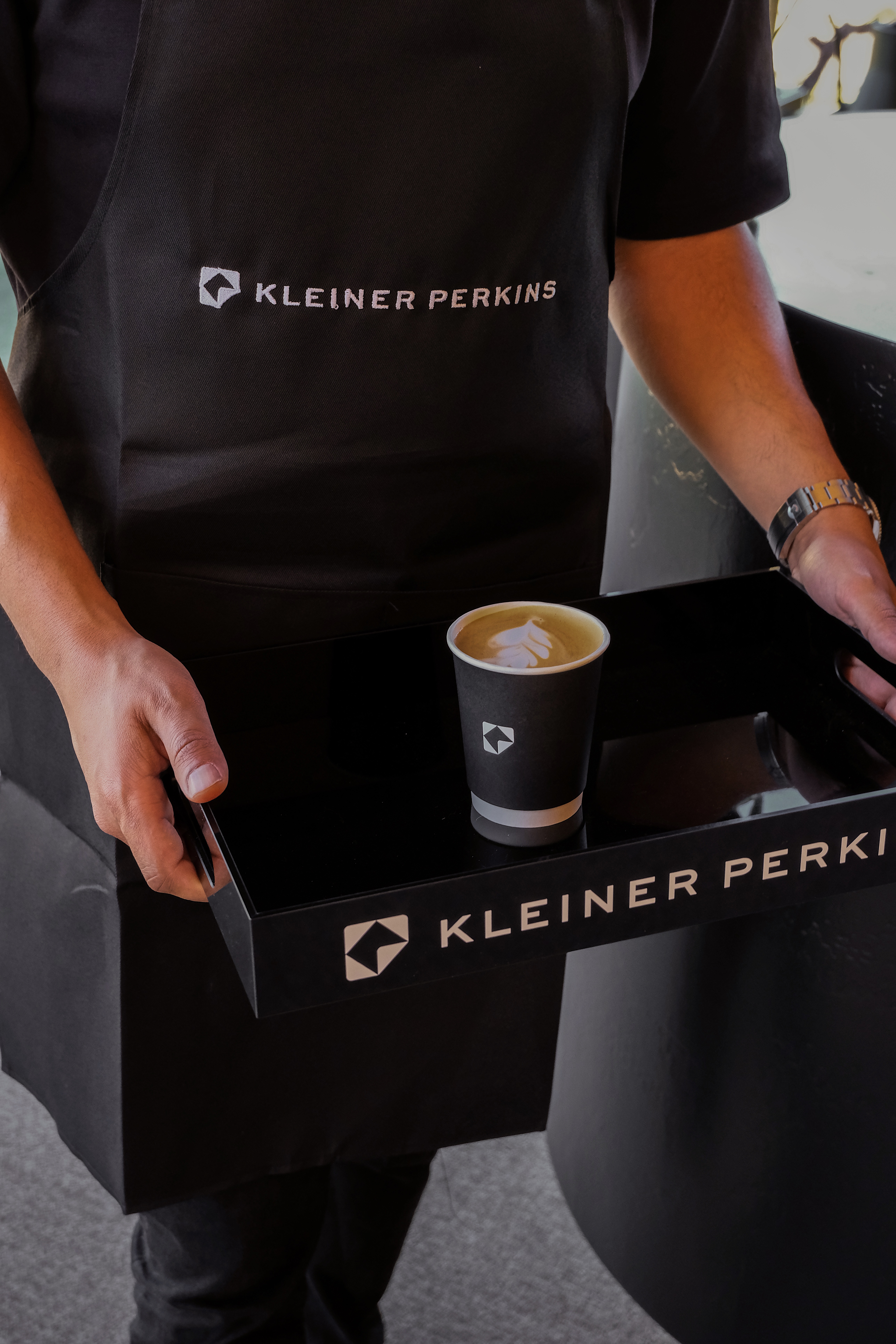 Custom branded serving tray and barista apron at a Fez Coffee brand activation.