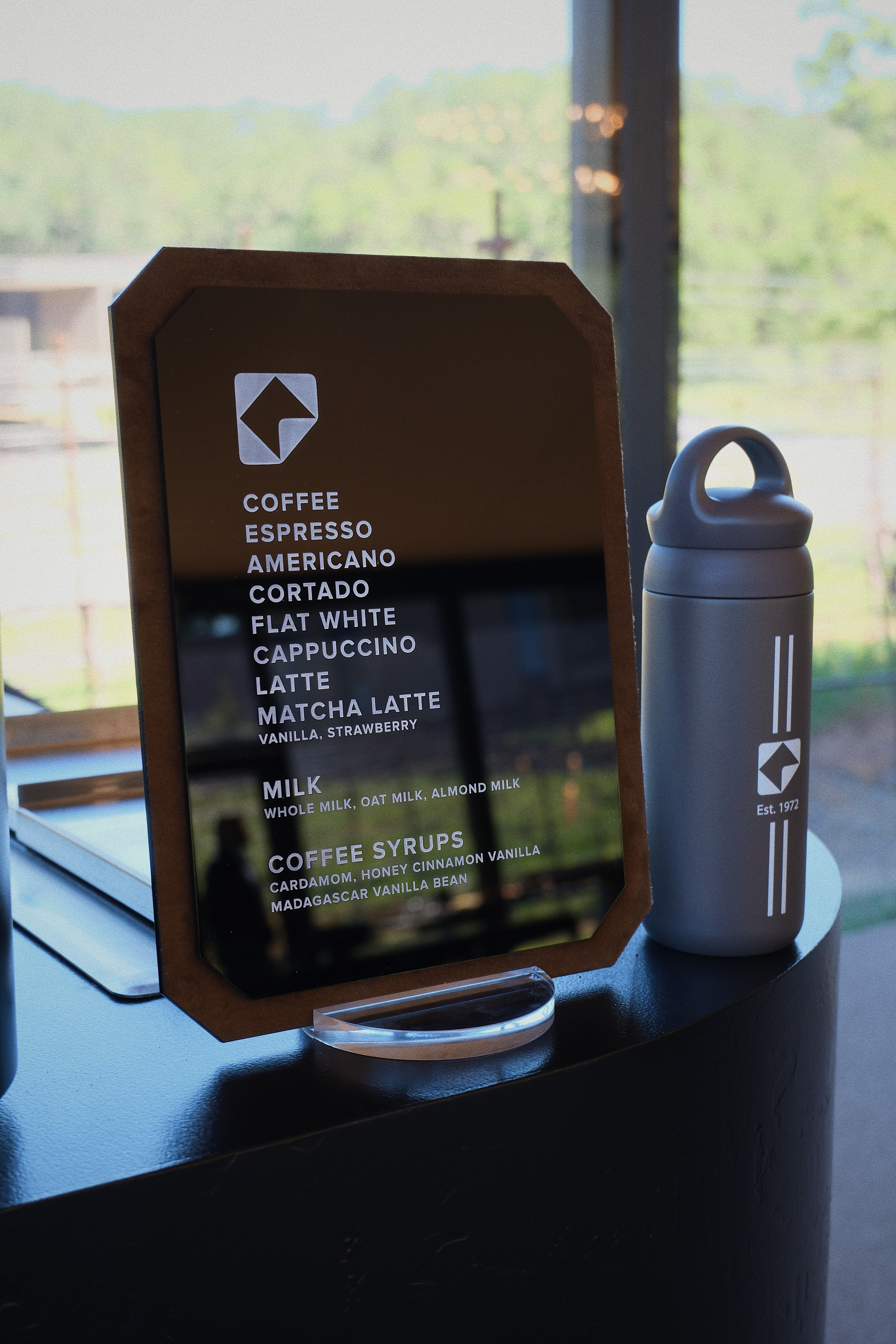 Custom printed menu board displayed on the Fez Coffee espresso cart at a brand activation.