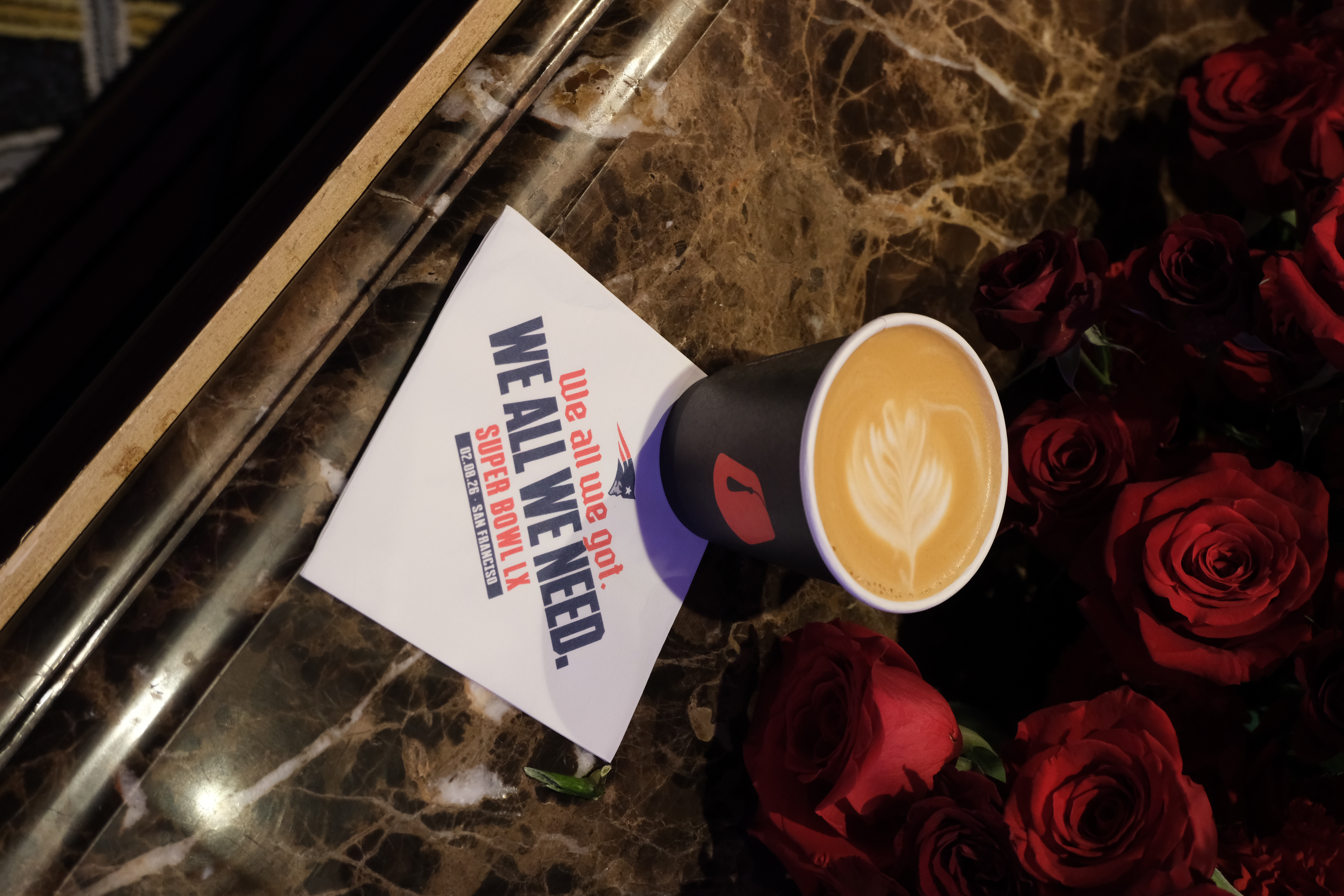 Fez Coffee branded cup on a custom New England Patriots napkin at a Super Bowl LX activation in San Francisco.